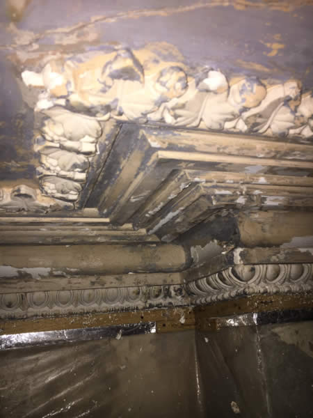 Stepped plaster cornice around a projecting corner before repainting at Clissold Crescent.